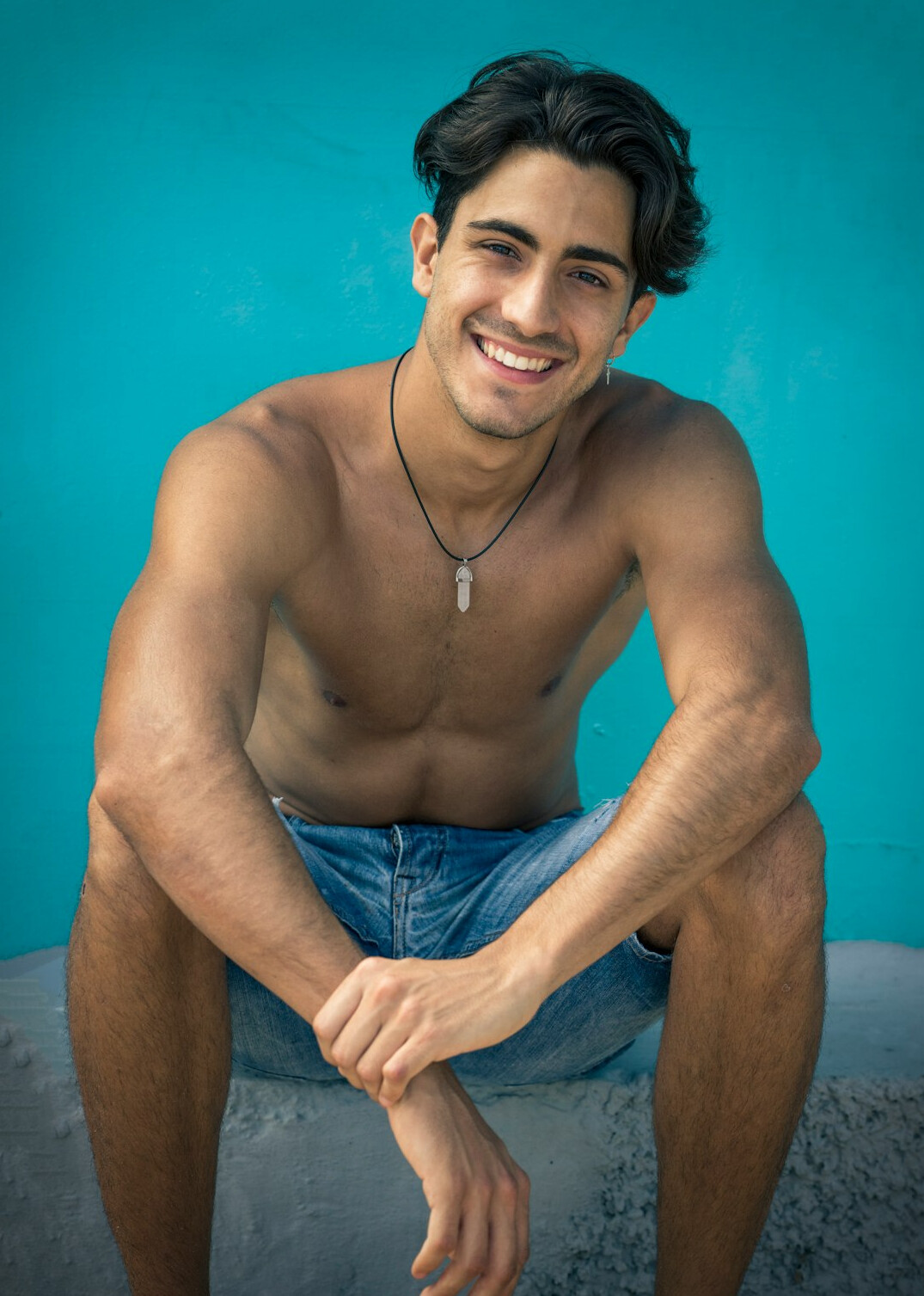 Latino man in his thirties smiling in a studio portrait